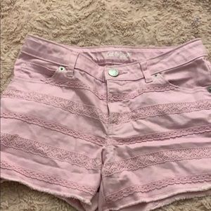 purple jean shorts with design going across.